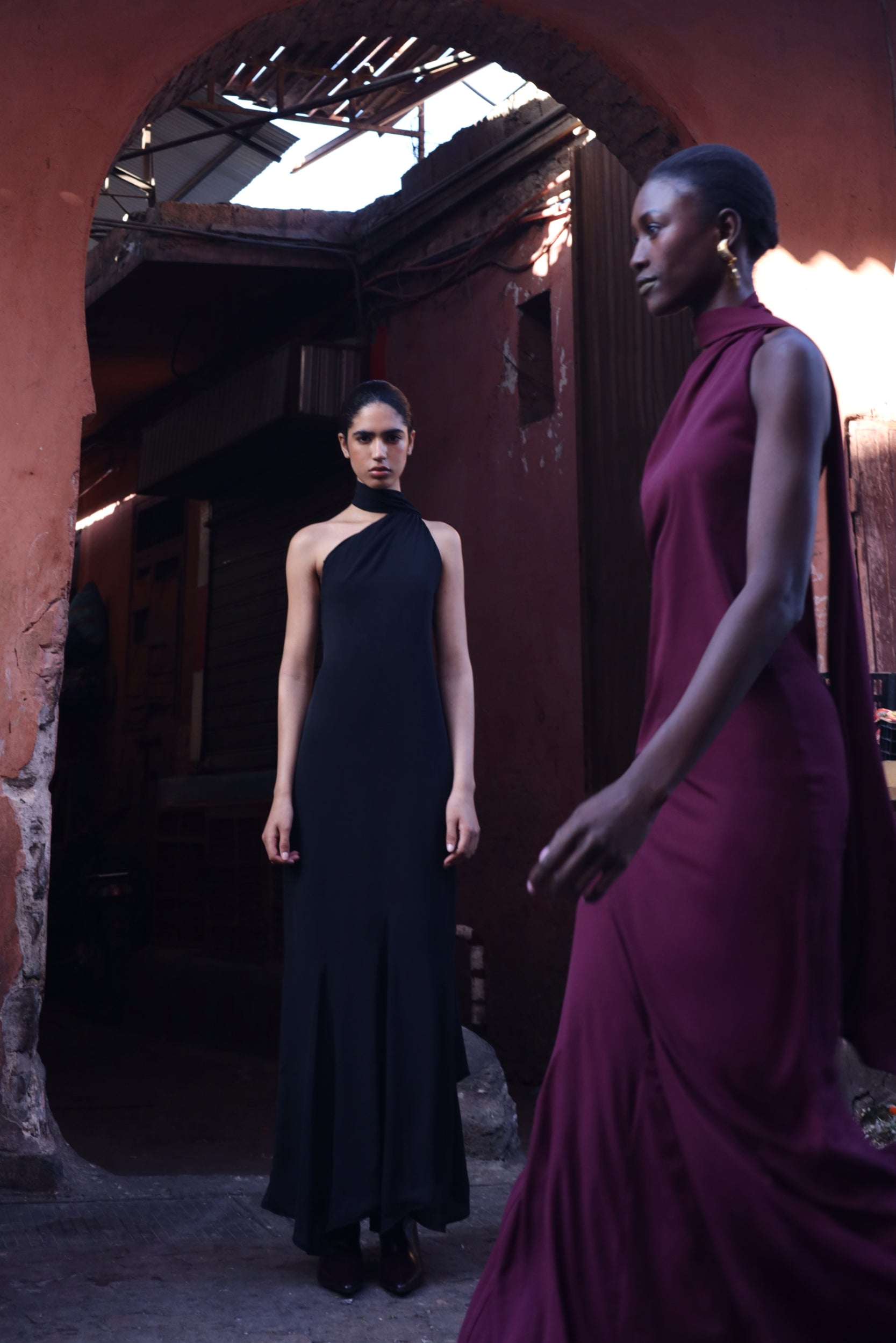 Vestido Ari negro con espalda abierta, banda decorativa y caída estructurada.